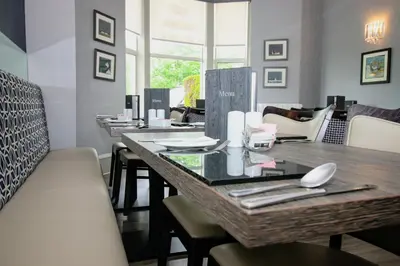 a dining room with a table and chairs at City Apartments in Glasgow