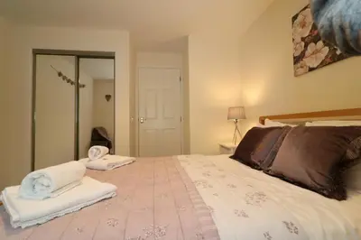 a bedroom with a large bed with towels on it at Signature - Douglas View Blantyre in High Blantyre