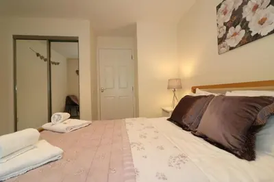a bedroom with a bed with two towels on it at Signature - Douglas View Blantyre in High Blantyre