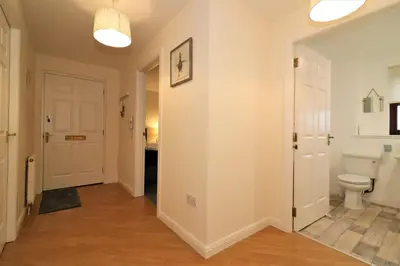 a bathroom with a toilet and a hallway at Signature - Douglas View Blantyre in High Blantyre