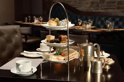 a table with a tray of food on a table at Golden Lion Hotel in Stirling