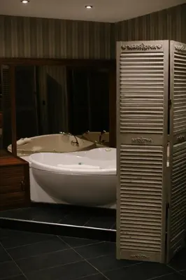 a large bath tub in a bathroom with a sink at Nira Caledonia in Edinburgh