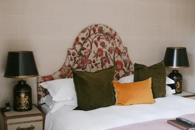 a bedroom with a bed with pillows and two lamps at Nira Caledonia in Edinburgh