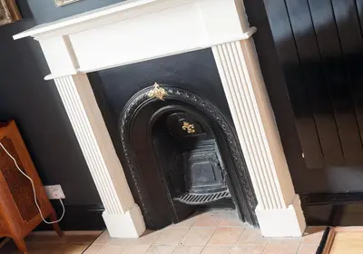a fireplace with a black and white mantel at The Castle Esplanade Residence in Edinburgh