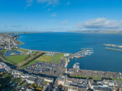 an aerial view of a harbor and the ocean at Quay Head View Aparthotel in Stranraer