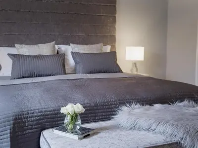 a large bed with a vase of flowers on a table at The Lane Hotel in Edinburgh
