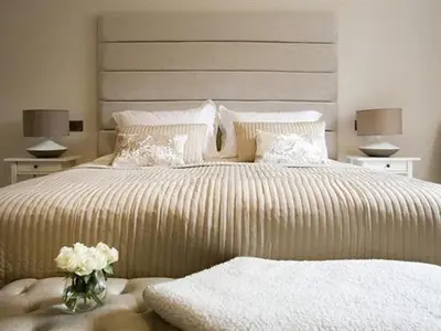 a bedroom with a large bed with a vase of flowers at The Lane Hotel in Edinburgh