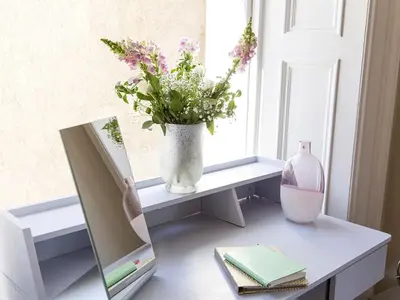 a table with a mirror and a vase with flowers at The Lane Hotel in Edinburgh