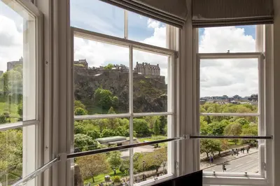 an open window with a view of a castle at Destiny Scotland - Chisholm Hunter Suites in Edinburgh