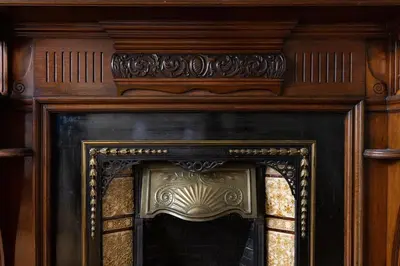 a fireplace with a wooden frame and a glass window at The Haymarket Hotel in Edinburgh