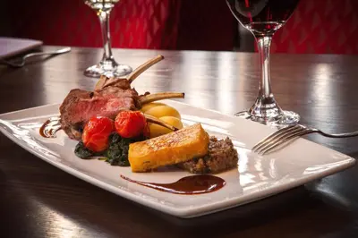 a plate of food with meat and vegetables on a table at Holiday Inn - Glasgow - City Ctr Theatreland by IHG in Glasgow