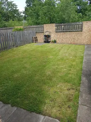 a yard with a fence and a lawn with a chair at Livingston 4 bedroom townhouse in Livingston