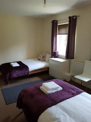 a bedroom with two beds and a window at Livingston 4 bedroom townhouse in Livingston