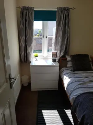 a bedroom with a bed and a window with a sink at Livingston 4 bedroom townhouse in Livingston