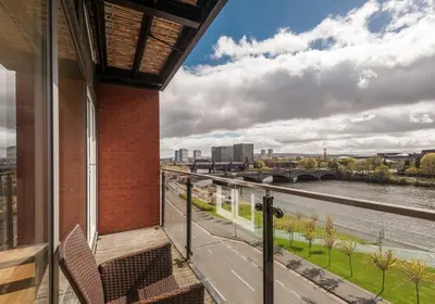 a balcony with a view of a river at The Metropole Residence in Glasgow
