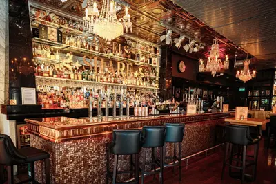 a bar with a bunch of bottles of alcohol at Angels Share Hotel in Edinburgh