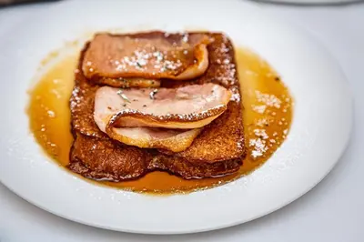 a plate with three pieces of bread with syrup at Angels Share Hotel in Edinburgh
