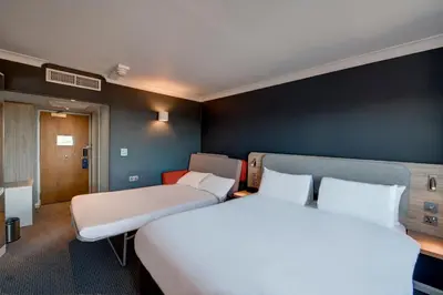 a hotel room with two beds and a bedvisor at Holiday Inn Express Edinburgh City West by IHG in Edinburgh