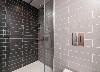 a bathroom with a shower with a glass door at Holiday Inn Express Edinburgh City West by IHG in Edinburgh