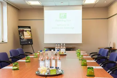 a conference room with a long table with bottles of alcohol at Holiday Inn Edinburgh Zoo by IHG in Edinburgh