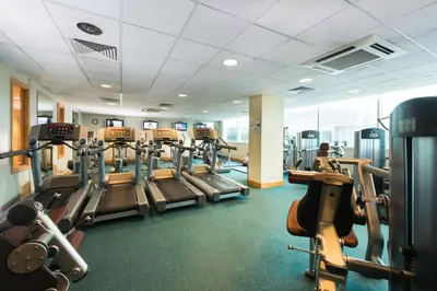 a gym with treadmills and elliptical machines at Holiday Inn Edinburgh Zoo by IHG in Edinburgh