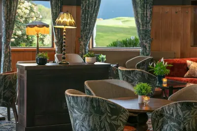 a hotel lobby with chairs and tables and a couch at Glasgow Westerwood Hotel, Spa & Golf Resort in Cumbernauld