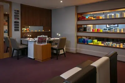 a restaurant with a bar with chairs and a counter at Glasgow Westerwood Hotel, Spa & Golf Resort in Cumbernauld