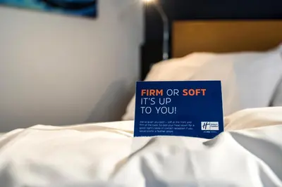 a book that says firm or soft its up to you on a bed at Holiday Inn Express Dunfermline by IHG in Dunfermline