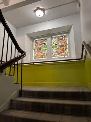 a staircase with two stained glass windows in a building at Safestay Glasgow Charing Cross in Glasgow