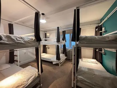 a dorm room with three bunk beds in it at Safestay Glasgow Charing Cross in Glasgow