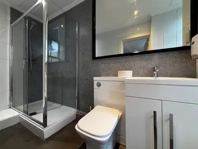 a bathroom with a shower and a toilet and a sink at Safestay Glasgow Charing Cross in Glasgow