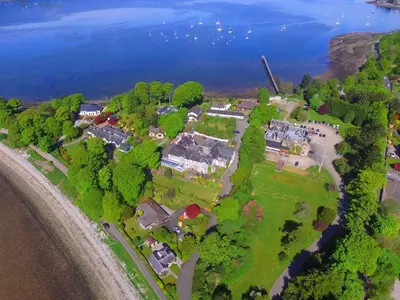 an aerial view of a house on a island in the water at Rosslea Hall Hotel in Rhu