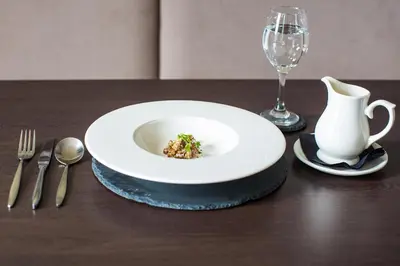 a table with a plate of food and a wine glass at Rosslea Hall Hotel in Rhu