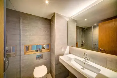 a bathroom with a toilet and a sink at Apex City of Glasgow Hotel in Glasgow