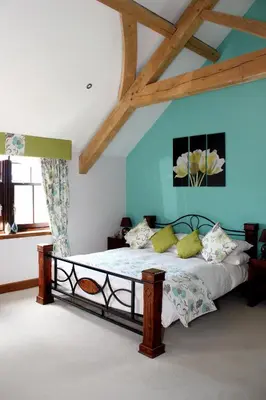 a bedroom with a bed in a room with blue walls at Backbrae House B&B in Lanark
