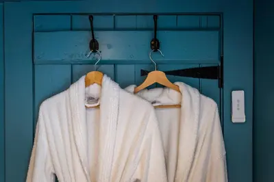 a rack with coats and towels on it at Cruickshanks Boutique B&B in Whiting Bay