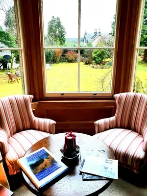 a room with two chairs and a table and a window at Lubnaig Guest House in Callander
