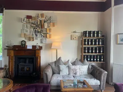 a living room with a couch and a fireplace at Creag Mhor Lodge in Onich