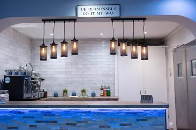 a kitchen with lights hanging over a swimming pool at The County Hotel in Helensburgh