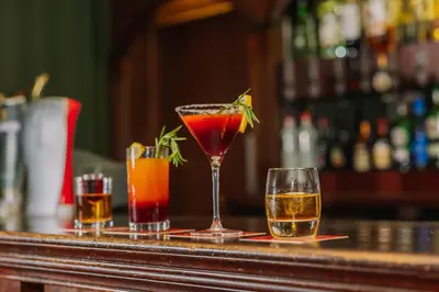 three cocktails sitting on a bar at Muthu Ben Doran Hotel in Tyndrum