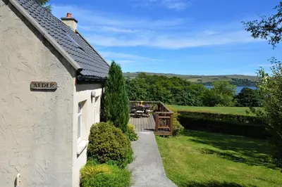 a house with a driveway leading to a garden at Alder Cottage in Blairmore