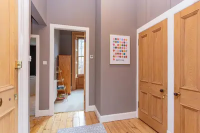a hallway with a door leading into a room at South Learmonth Gardens Apartment in Edinburgh