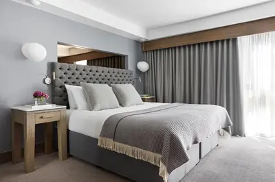 a bedroom with a large bed and a window at Kimpton Blythswood Square Hotel & Spa by IHG in Glasgow