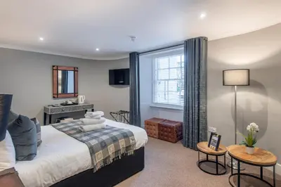 a hotel room with a bed and a desk at The Allan Park in Stirling