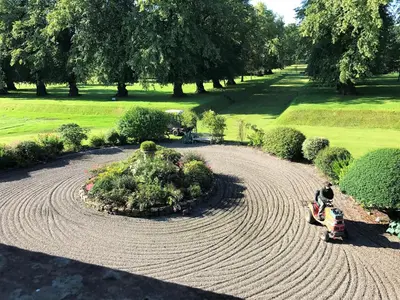 an aerial view of a garden with a person in a field at Carnell Country Estate & Holiday Cottages in Ayrshire in Hurlford