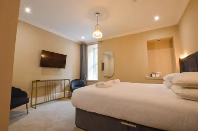 a hotel room with a bed and a mirror at Dalrigh House in Oban