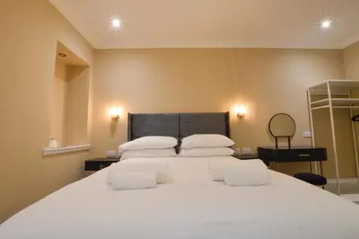 a bedroom with a large white bed with white pillows at Dalrigh House in Oban
