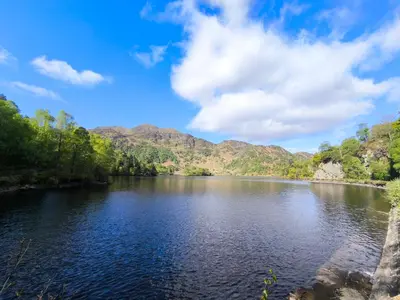 a view of a river with mountains in the background at Rob Roy Hotel in Aberfoyle