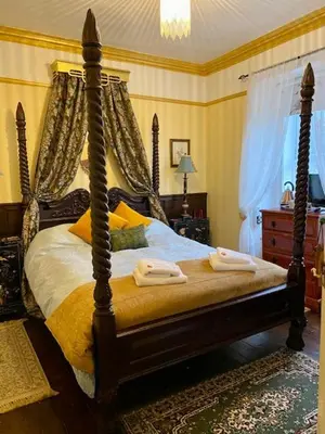 a bedroom with a bed with two towels on it at Rosebank House Bed & Breakfast in Strathyre