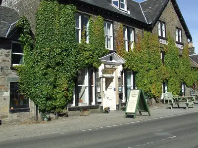 a building with a sign in front of it at Garbhein Bed & Breakfast in Kilmelford
